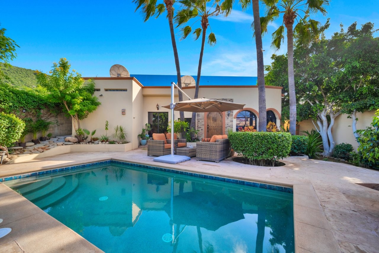 The home opens toward the pool courtyard