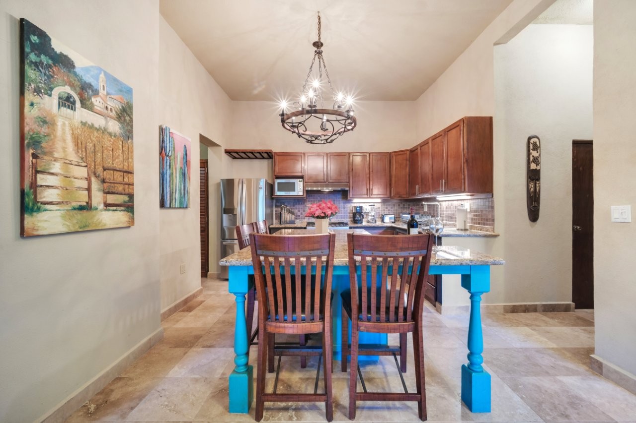 Kitchen and dining area beneath high ceilings