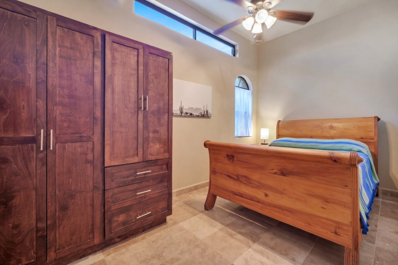Bedroom with high ceilings and built-in storage