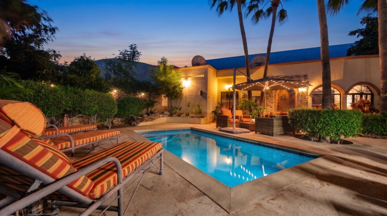 Illuminated pool and tropical garden